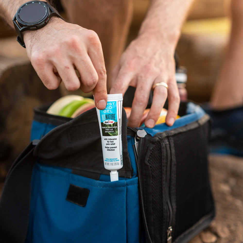 Placing First Aid Gel into Disc Golf bag