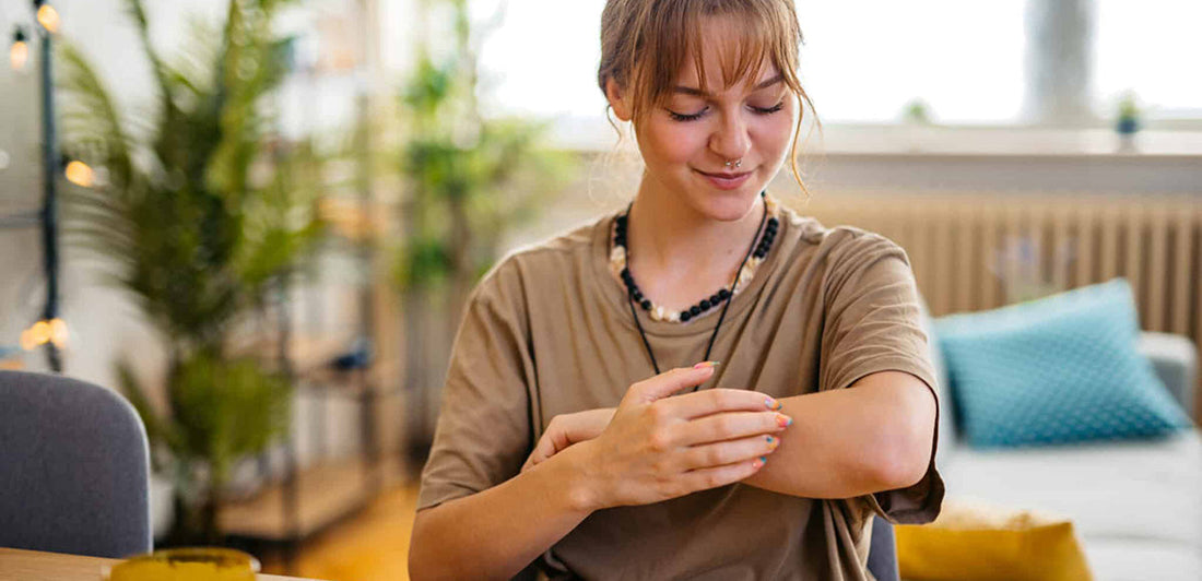 Woman scratching her arm