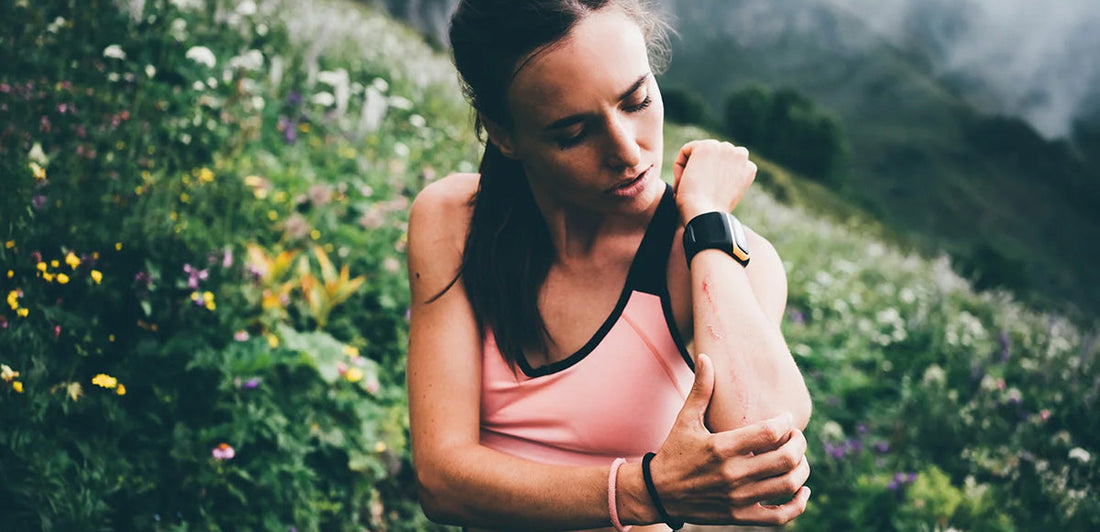 Woman looking at rash on her arm