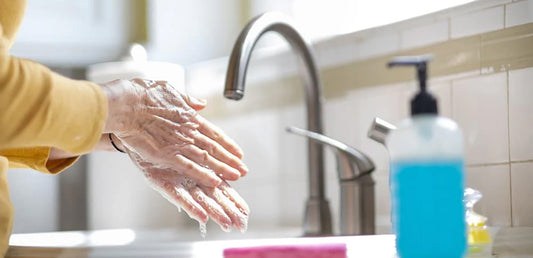 washing hands in kitchen sink