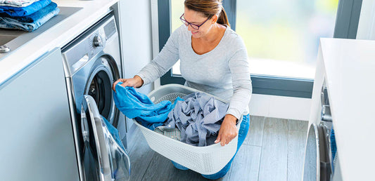 woman washing clothes in a washer