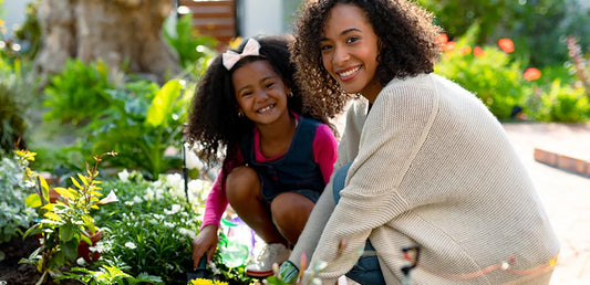 Mom and daughter working in garden