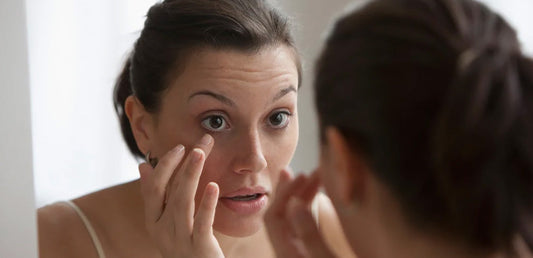 Woman looking closely at her eye