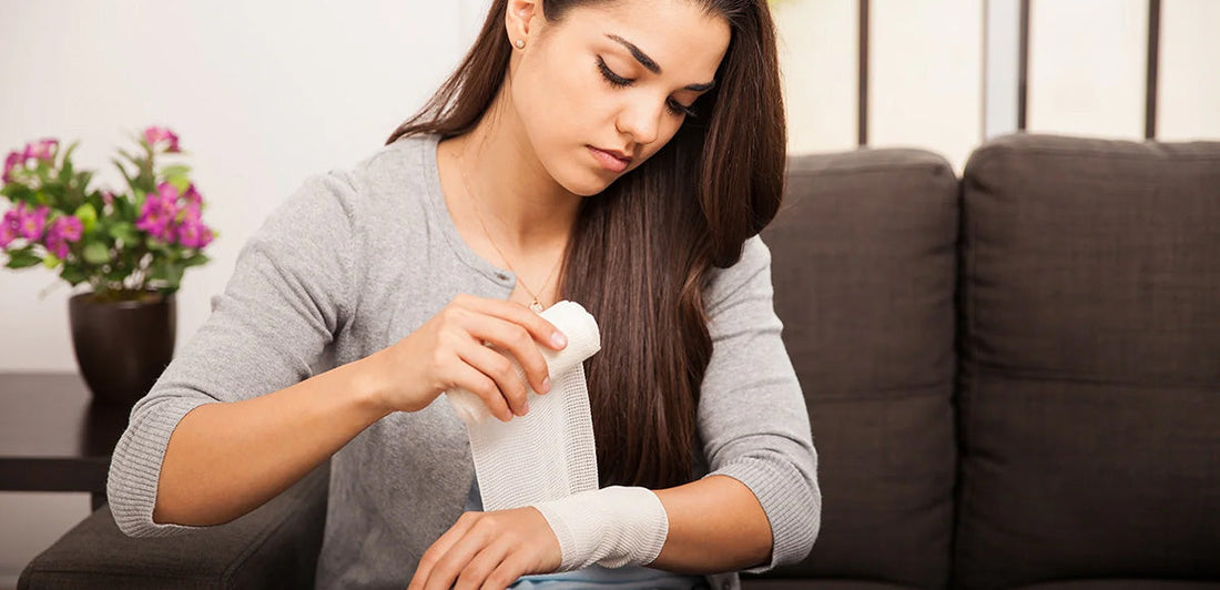 Girl bandaging her arm