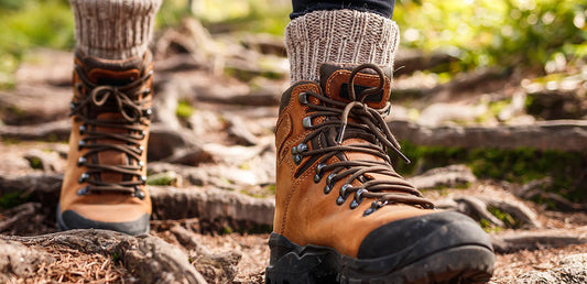 close up of hiking boots walking on a trail