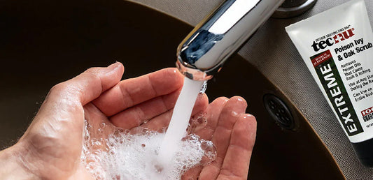 Washing hands in sink with Tecnu Extreme