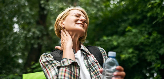 Woman rubbing mosquito bite on neck