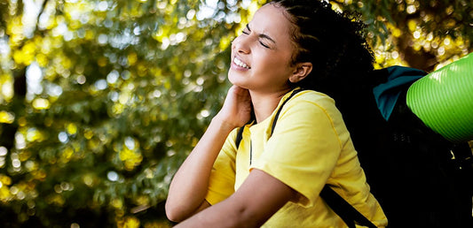 backpacking woman scratching at her neck