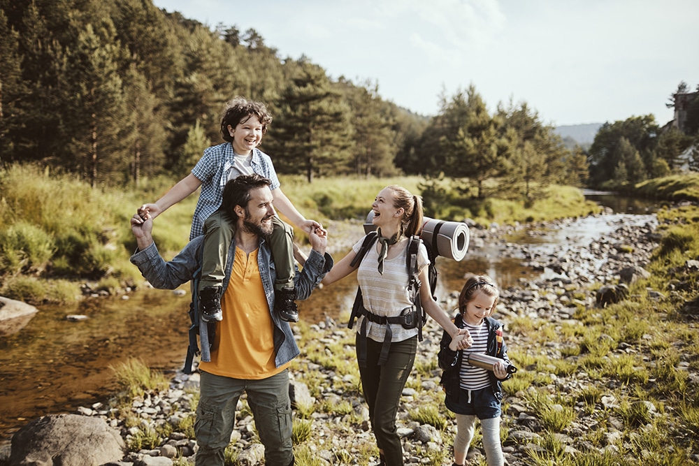 A young family is having fun hiking along the stream.
